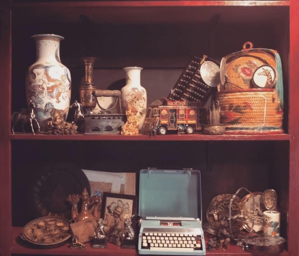 Vintage cabinet of Chinese vases, brassware and a typewriter, the medicine-hall inspiration behind Oriental Elixir