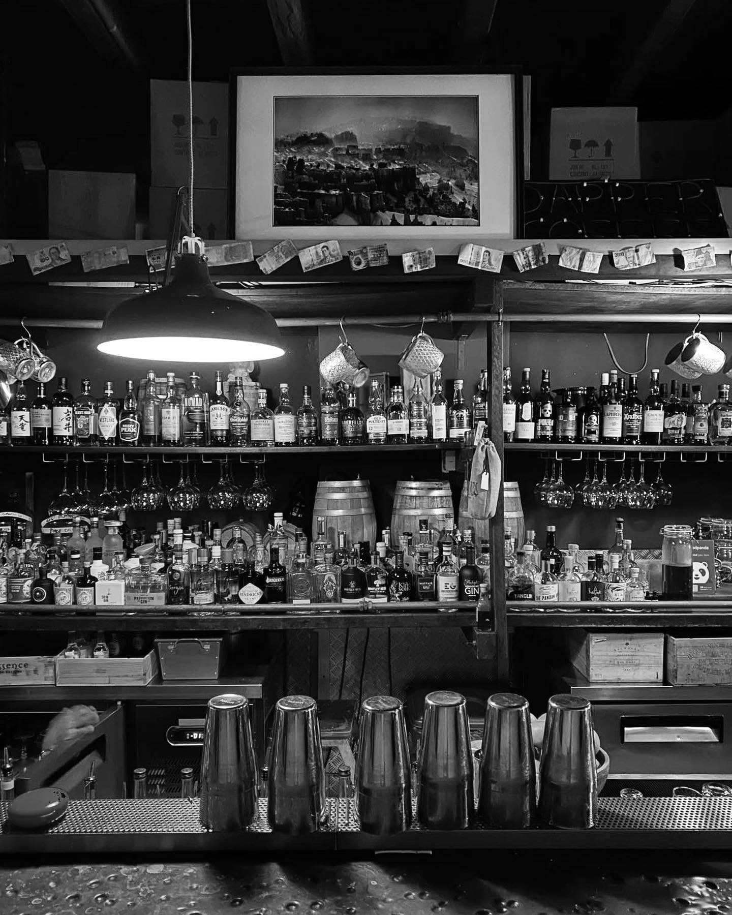 Moody back bar shelved with spirits at The Spiffy Dapper